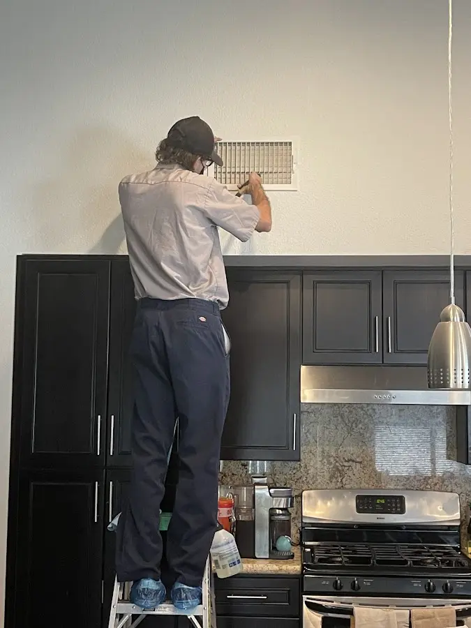 Technician inspecting an air vent during HVAC service in Schuylkill Haven